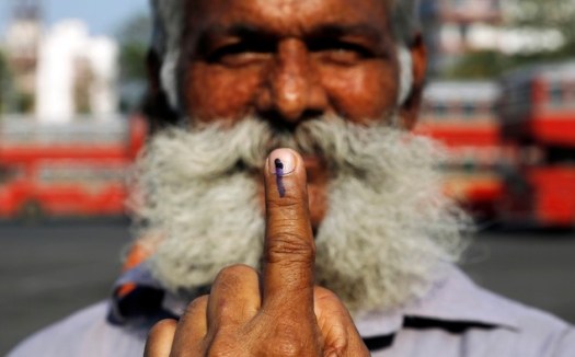 An Indian man displays the indelible ink mark on his finger after casting his vote in Mumbai India - source www.dailymail.co.uk