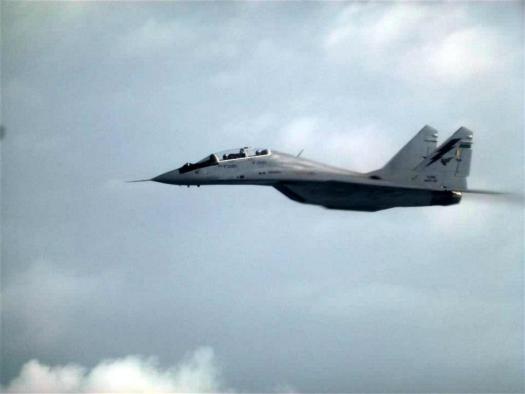 An RMAF Mikoyan-Gurevich MiG-29NUB flying alongside the C-130H the writer was in